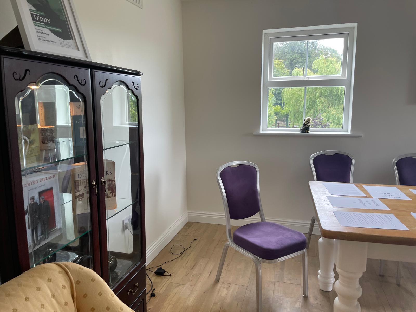 Glass cabinet with table and chairs